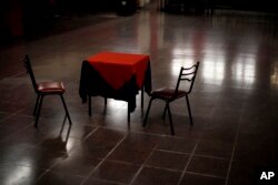A table and chairs sit amid the empty dance floor of La Viruta Tango club, closed during the COVID-19 pandemic lockdown in Buenos Aires, Argentina, Friday, June 4, 2021.