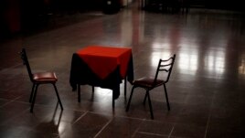 A table and chairs sit amid the empty dance floor of La Viruta Tango club, closed during the COVID-19 pandemic lockdown in Buenos Aires, Argentina, Friday, June 4, 2021.