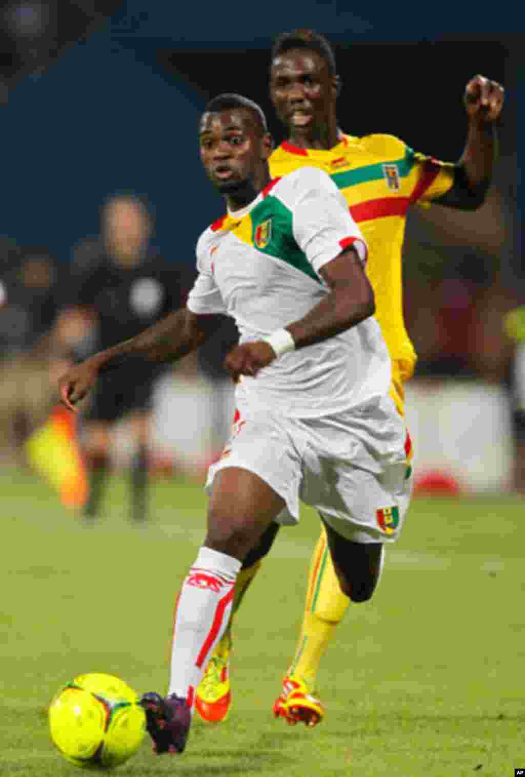 Guinea's Abdoul Razzagui Camara challenges Mali's Modibo Maiga for the ball during their African Nations Cup Group D soccer match at Franceville Stadium