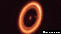 This image, taken with the Atacama Large Millimeter/submillimeter Array (ALMA), shows the PDS 70 system, located nearly 400 light-years away. It features a star at its centre and at least two planets orbiting it, PDS 70b (not visible in the image) and PDS