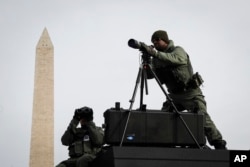 SWAT personnel keep watch beside the Washington Memorial in Washington, Jan. 19, 201.