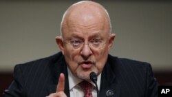 FILE - U.S. intelligence chief James Clapper, shown testifying before Congress in February 2014, says a U.S. decision to arm Ukraine could spur Russia to give more advanced weaponry to the separatists.