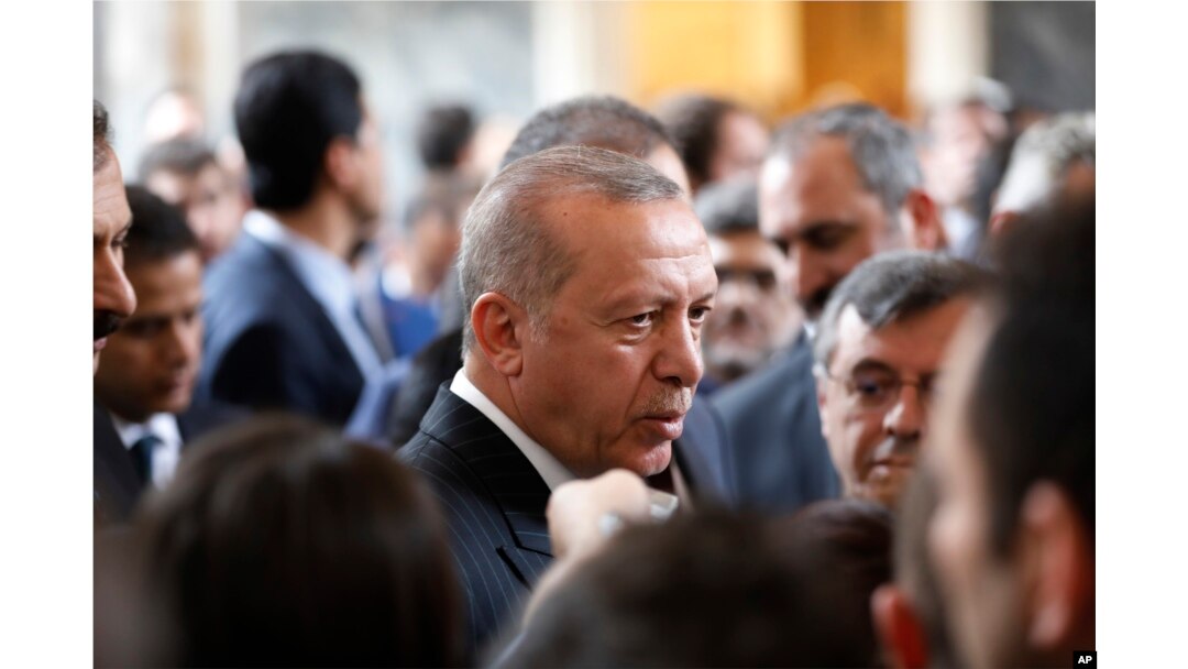 Turkey's President Recep Tayyip Erdogan, talks to MPs of his ruling Justice and Development Party (AKP) after delivering a speech at the parliament in Ankara, Turkey, Tuesday, Nov. 20, 2018.