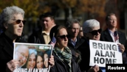 FILE - Demonstrators gather during a rally for U.S. detainee Alan Gross in Lafayette Square in Washington, Dec. 3, 2013. 