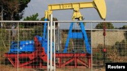 An oil pumpjack painted with the colors of the Venezuelan flag is seen in Lagunillas, Venezuela, Jan. 29, 2019.