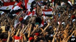 Egyptians listen to the speech of Egypt's President-elect Mohamed Morsi, in Tahrir Square in Cairo, Egypt, Friday, June 29, 2012.