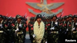 Soldiers salute Burma's army chief General Min Aung Hlaing during a parade in Naypyitaw, Mar. 27, 2012. 