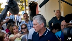 Cuba's President Miguel Diaz-Canel talks to the press after voting in a referendum to approve or reject the new constitution in Havana, Cuba, Sunday, Feb. 24, 2019. 