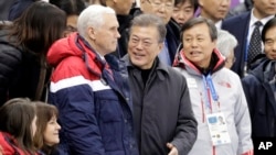 U.S. Vice President Mike Pence, center left, and South Korean President Moon Jae-in attend the women's 500 meters short-track speedskating in the Gangneung Ice Arena at the 2018 Winter Olympics in Gangneung, South Korea, Feb. 10, 2018. U.S. second lady Karen Pence is seen bottom left.
