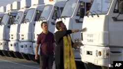 Mục sư Giáo hội Chính thống Nga ban phước cho một đoàn xe tải viện trợ nhân đạo ở Alabino, ngoại ô Moscow, ngày 12/8/2014. Nga cho biết họ đang đưa 280 xe tải chở hàng cứu trợ tới các cư dân ở miền đông Ukraine.