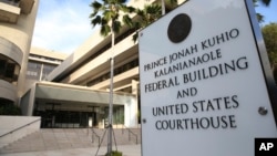 FILE - A sign for the Hawaii U.S. federal court stands outside the building in Honolulu on Wednesday morning, March 15, 2107.