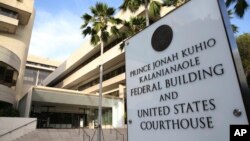 FILE - A sign for the Hawaii U.S. federal court stands outside the building in Honolulu on Wednesday morning, March 15, 2107. 