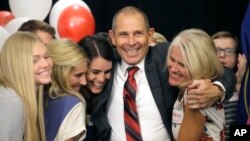 Provo Mayor John Curtis celebrates with his family after winning Utah's Republican primary to fill the U.S. House seat vacated by Jason Chaffetz, Aug. 15, 2017, in Provo, Utah. 