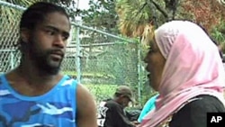 A member of Project Downtown talks to a homeless man in Tampa, Florida