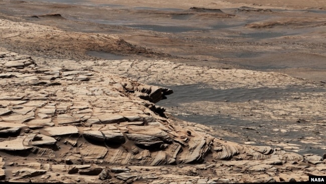 This photo, compiled from 28 images, shows the view from NASA’s Curiosity Mars rover on April 9, 2020. It shows the landscape of the Stimson sandstone formation in Gale Crater. (Photo Credit: NASA/JPL-Caltech/MSSS)