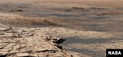 This photo, compiled from 28 images, shows the view from NASA’s Curiosity Mars rover on April 9, 2020. It shows the landscape of the Stimson sandstone formation in Gale Crater. (Photo Credit: NASA/JPL-Caltech/MSSS)
