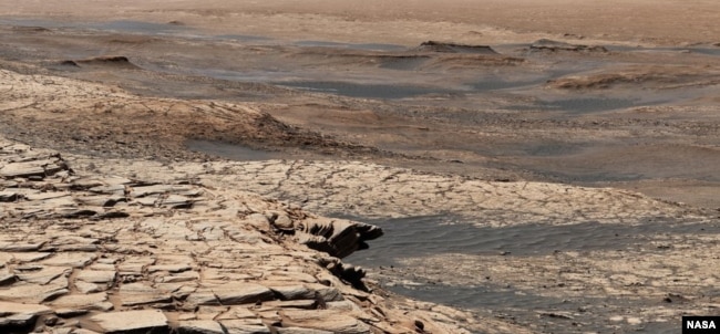 This photo, compiled from 28 images, shows the view from NASA’s Curiosity Mars rover on April 9, 2020. It shows the landscape of the Stimson sandstone formation in Gale Crater. (Photo Credit: NASA/JPL-Caltech/MSSS)