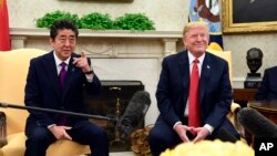 FILE - President Donald Trump meets with Japanese Prime Minister Shinzo Abe in the Oval Office of the White House in Washington, June 7, 2018. 