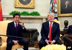 President Donald Trump meets with Japanese Prime Minister Shinzo Abe in the Oval Office of the White House in Washington, June 7, 2018.