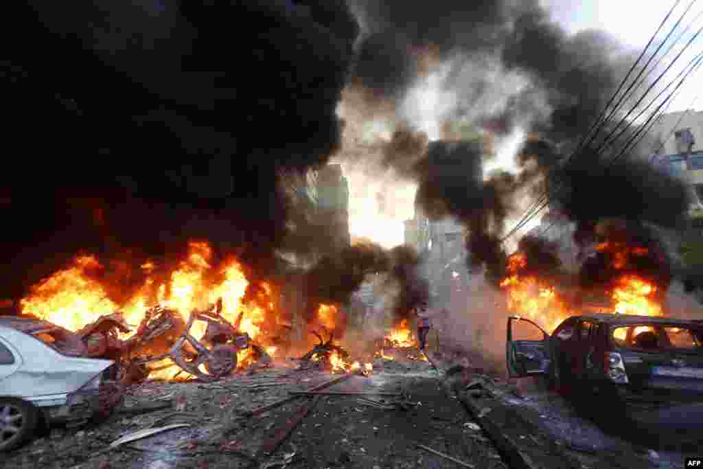 Flames rise from burning cars at the site of a car bomb in Beirut&#39;s southern suburb of Haret Hreik, Jan. 2, 2014. A large car bomb killed five people and injured at least 20, a health ministry source told AFP.