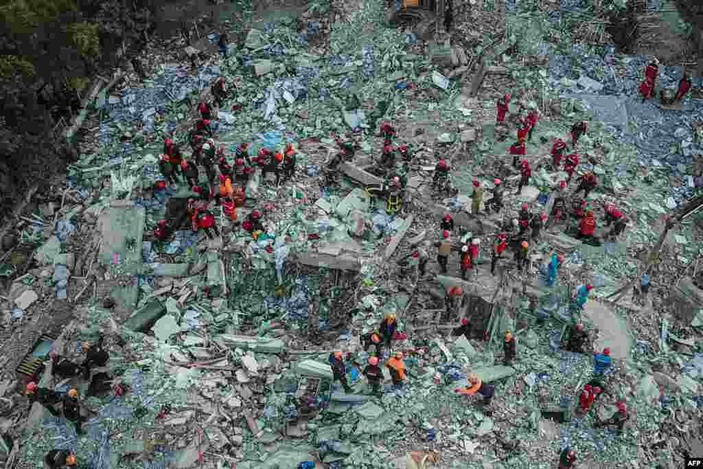 An aerial view taken on Oct. 31, 2020, shows rescue workers searching for survivors in a collapsed building in Izmir, after a powerful earthquake struck Turkey's western coast and parts of Greece.