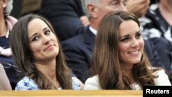 Britain's Catherine, Duchess of Cambridge (R) sits with her sister Pippa Middleton on Centre Court for the men's singles final tennis match at the Wimbledon Tennis Championships in London.