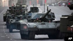 Russian military vehicles including the new Russian T-14 Armata tank, center, make their way to Red Square during a rehearsal for the Victory Day military parade which will take place on May 9 to celebrate 70 years after the victory in WWII, in Moscow, May 4, 2015.