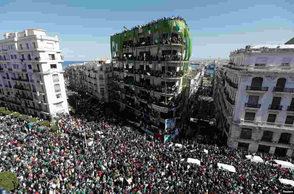 People gather during a protest over President Abdelaziz Bouteflika's decision to delay elections and extend his fourth term in office, in Algiers, Algeria.