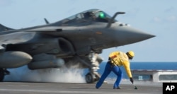 Photo, released Nov. 23, 2015 by the French Army Communications Audiovisual office (ECPAD), shows a French army Rafale fighter jet taking off from the deck of France's aircraft carrier Charles De Gaulle, in the Mediterranean sea.