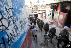 U.N. peacekeepers from Brazil patrol the Cite Soleil slum in Port-au-Prince, Haiti, Feb. 22, 2017. They faced no greater threat than a few barking dogs along some of the same streets where pitched gunbattles between gangs and U.N. peacekeepers used to be a daily occurrence.