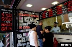 People change money at a currency exchange office in Istanbul, Turkey, Aug. 10, 2018.