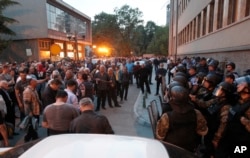 FILE - Police block protesters from entering the parliament building in Skopje, Macedonia, April 27, 2017.