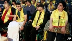 Hezbollah fighters wounded in Syria listen to a speech by their leader, Sheikh Hassan Nasrallah, this month in Beirut.