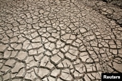 Cracked ground is pictured at the dried Ajuan Khota dam, a water reserve affected by drought near La Paz, Bolivia, Nov. 17, 2016. (Photo Reuters / David Mercado)