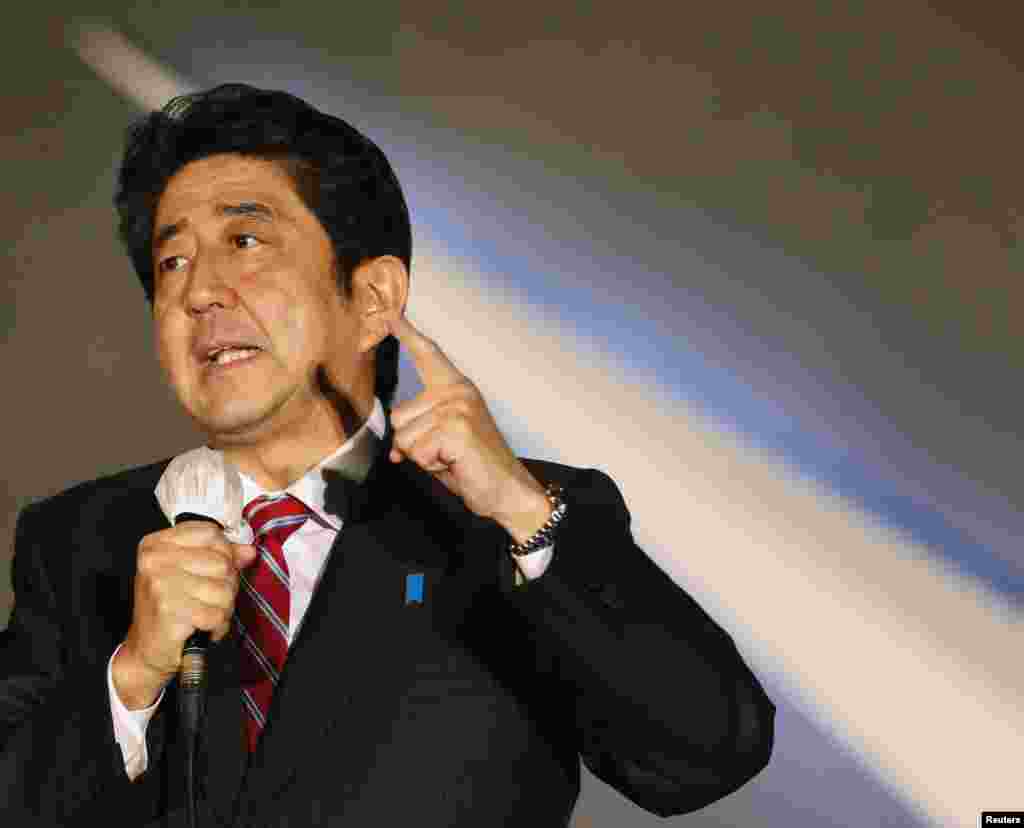 Shinzo Abe speaks to voters atop a campaign van at Akihabara electronics store district in Tokyo, December 15, 2012. 