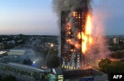 This handout image received by local resident Natalie Oxford early on June 14, 2017 shows flames and smoke coming from a 27-storey block of flats after a fire broke out in west London.