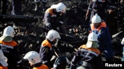 13일 러시아 비상사태부 직원들이 노브고로드주 루카 마을의 정신병동에서 발생한 화재 현장에서 사체를 옮기고 있다.