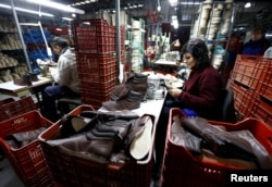 Workers manufacture security footwear at the Boris factory plant in Quilmes, Argentina, May 19, 2016.