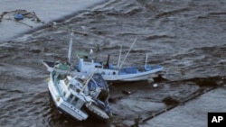 Fishing boats are swept by a tsunami in Oarai City in Ibaragi Prefecture, northeastern Japan March 11, 2011.