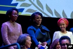 FILE - From left, Lauren Underwood, D-Ill., Ayanna Pressley, D-Mass., and Ilhan Omar D-Minn., are pictured during the swearing-in ceremony of Congressional Black Caucus members of the 116th Congress at the Warner Theatre in Washington, Jan. 3, 2019.