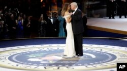 FILE - President Donald J. Trump dances with first lady Melania Trump at The Salute To Our Armed Services Inaugural Ball, Jan. 20, 2017, in Washington. 