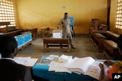 A man casts his vote during the Presidential elections in Briqueterie Cameroon, Oct. 7, 2018.