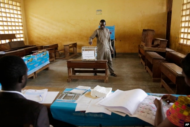 A man casts his vote during the Presidential elections in Briqueterie Cameroon, Oct. 7, 2018.