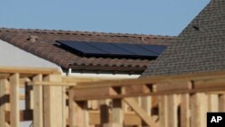 Solar panels are seen on the rooftop on a home in a new housing project in Sacramento, Calif., May 7, 2018.