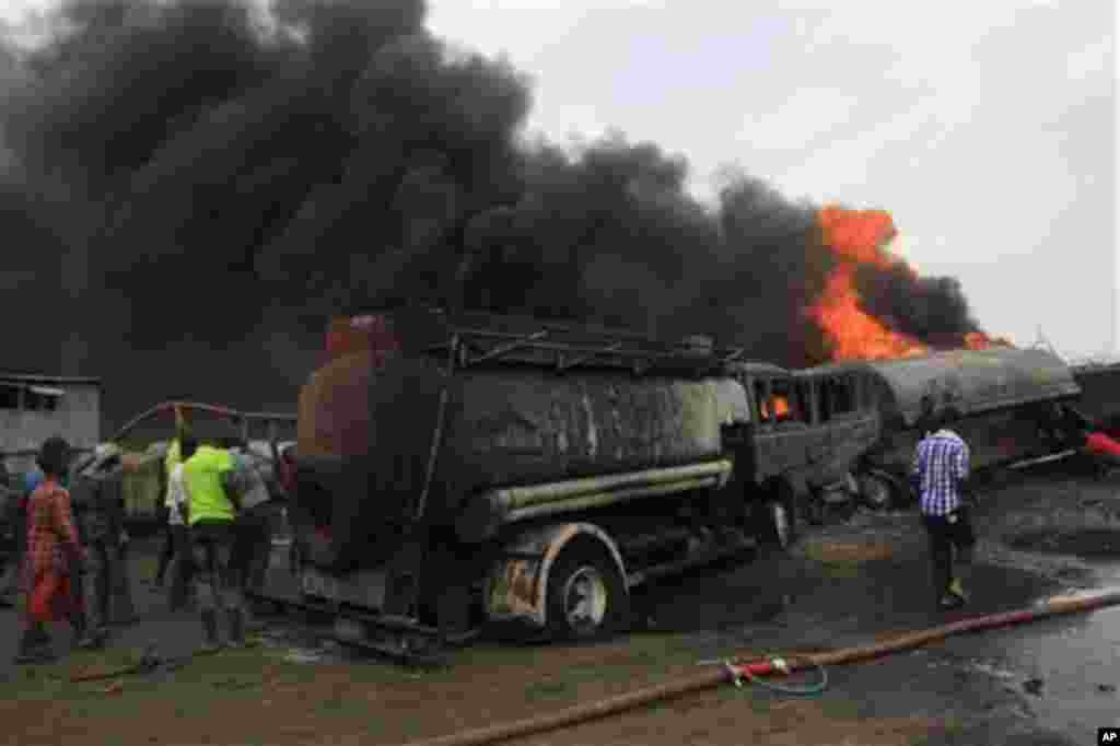 Firefighters try to contain a fire at an informal diesel fuel depot in Lagos, Nigeria on Thursday, Feb. 16, 2012.