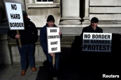 FILE - Anti-Brexit campaigners Borders Against Brexit protest outside Irish government buildings in Dublin, Ireland, April 25, 2017.