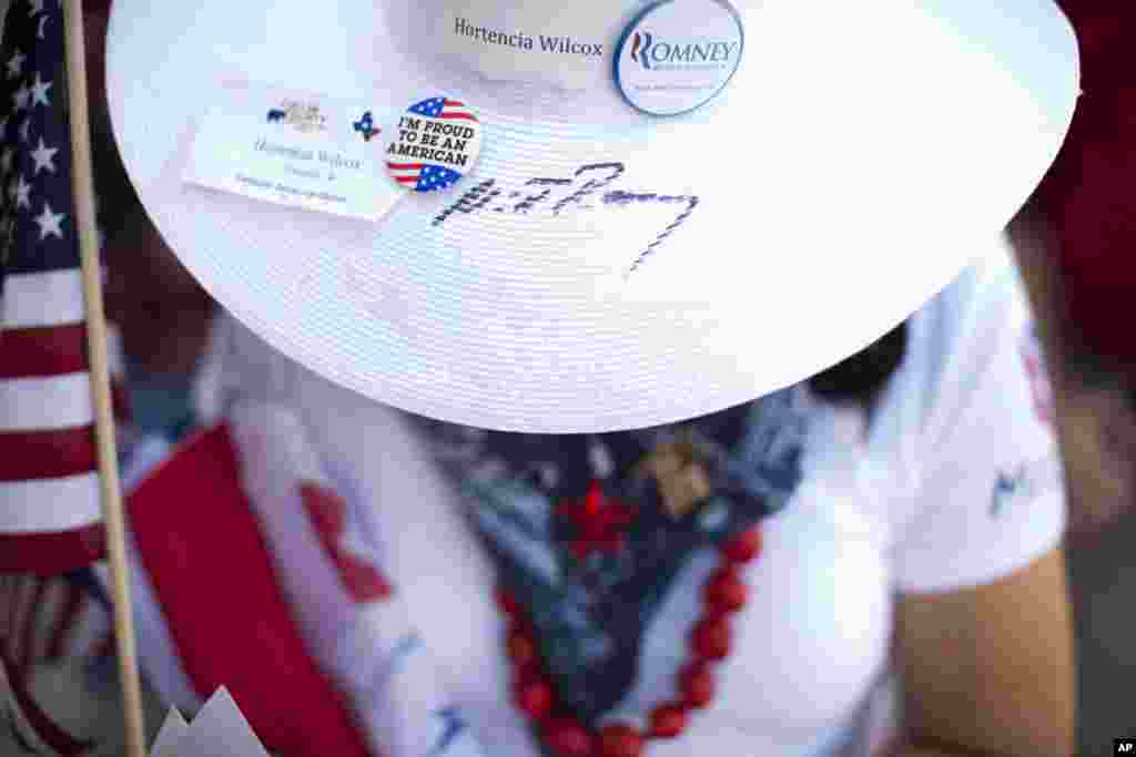 Hortencia Wilcox of Allen, Texas wears a hat signed by Republican presidential candidate, former Massachusetts Gov. Mitt Romney while waiting in line at a campaign stop in Fort Worth, Texas, June 5, 2012. (AP)