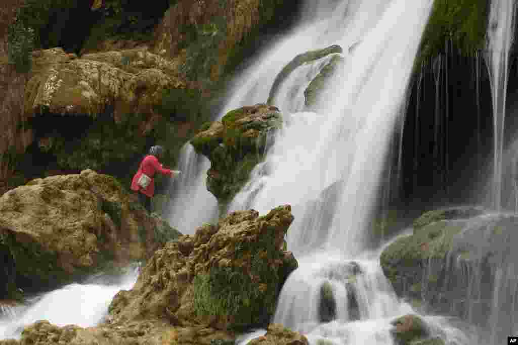 Tourist refresh themselves at the Kravice waterfalls on the Trebizat River , 200 kms south of Bosnian capital of Sarajevo.