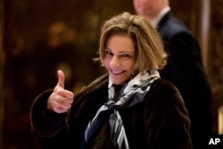 FILE - K.T. McFarland, deputy national security adviser for President-elect Donald Trump, give a thumbs up to members of the media as she arrives at Trump Tower in New York, Jan. 3, 2017.