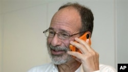 Alvin Roth takes a phone call after being awarded the Nobel economics prize, at his home in Menlo Park, California, October 15, 2012.